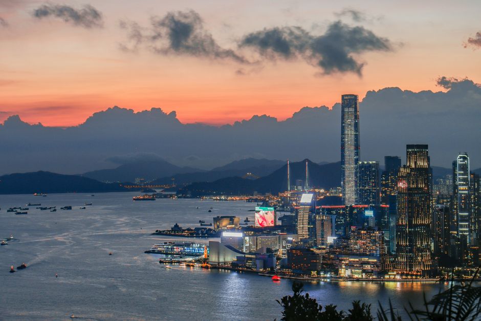 Stunning view of Hong Kong Island skyline with vibrant sunset colors over Victoria Harbour.
